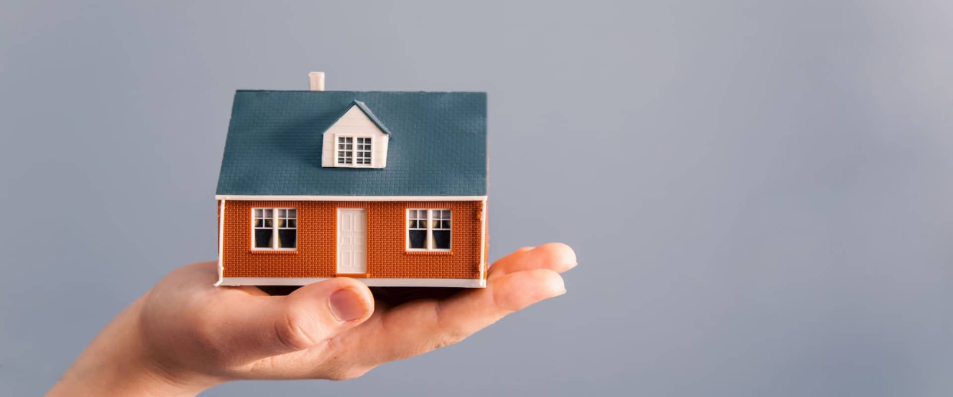 Человек демонстрирует объект недвижимости на руке