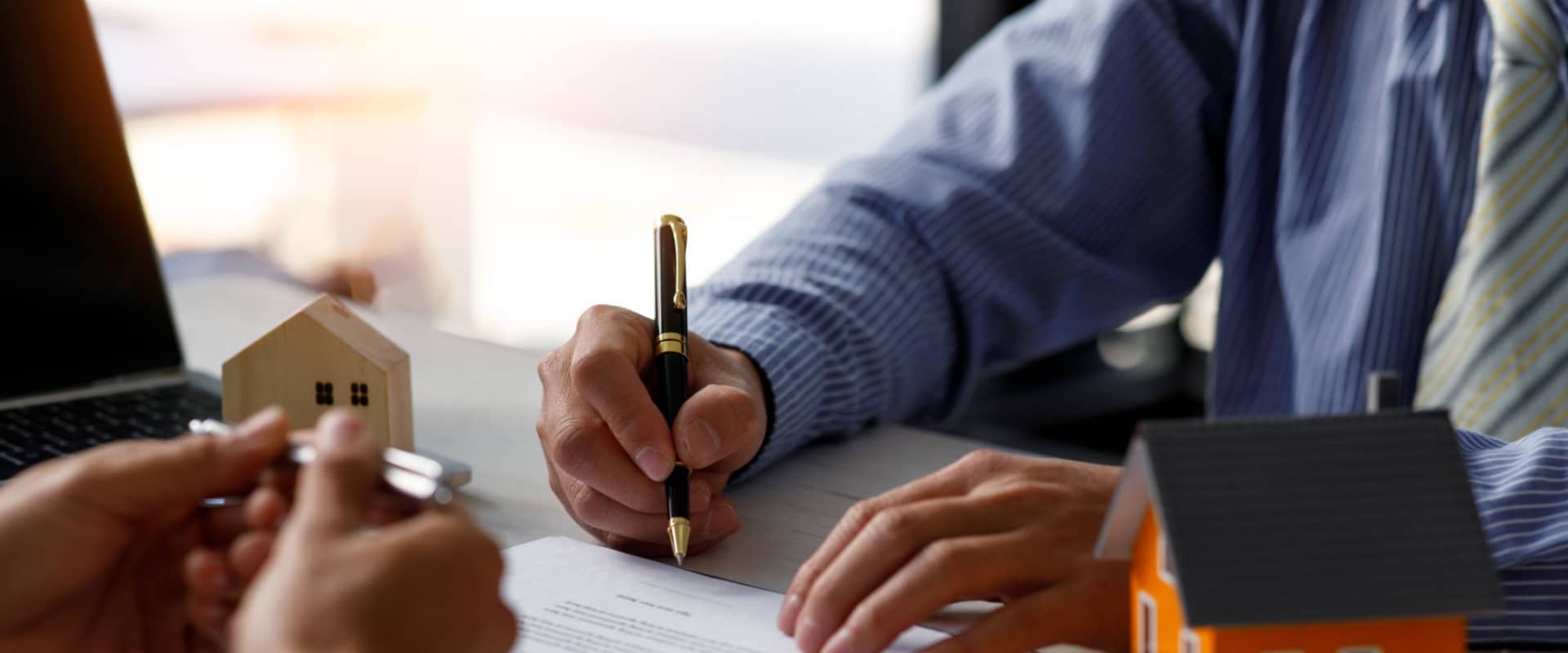 Человек подписывает договор купли-продажи на свою вторичную квартиру